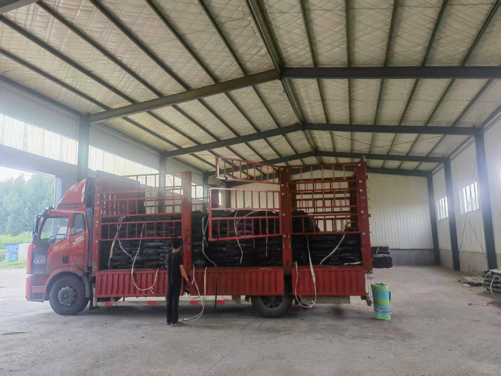 Finished reclaimed rubber sheets arranged inside the Xinyuan workshop